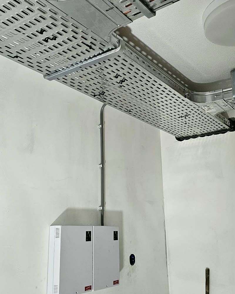 Kabelgoten aan het plafond met een aansluitkast aan de wand